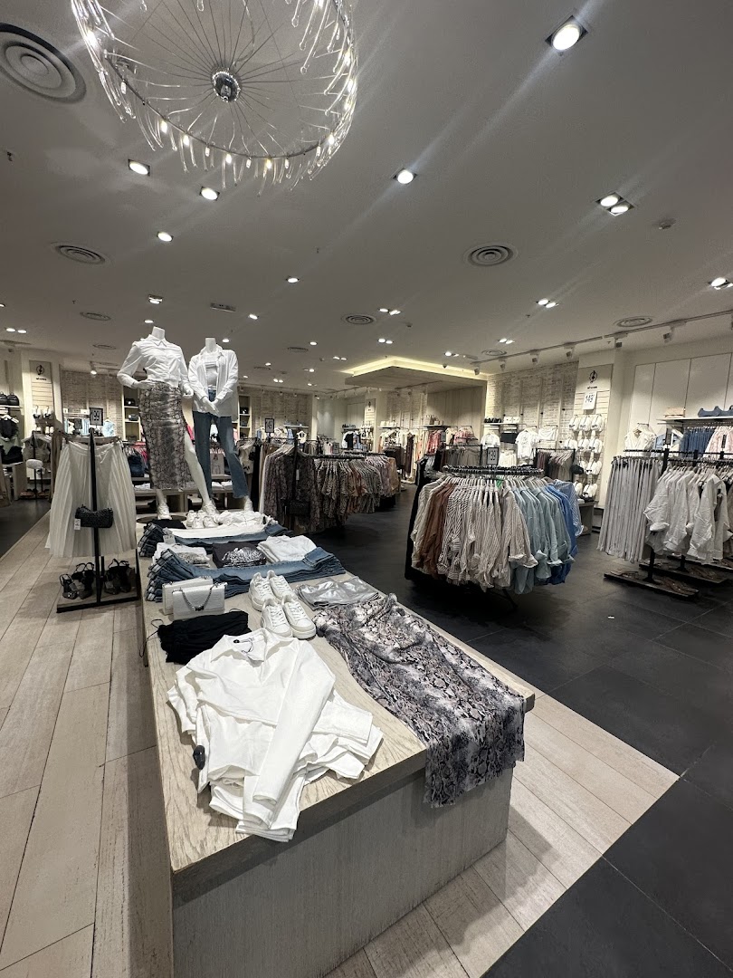 Interior view of a Stradivarius clothing store showcasing mannequins and racks of fashionable apparel.