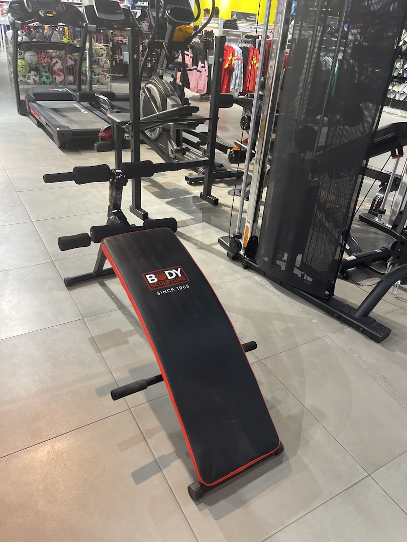 Interior shot of a sports store featuring exercise equipment and apparel.