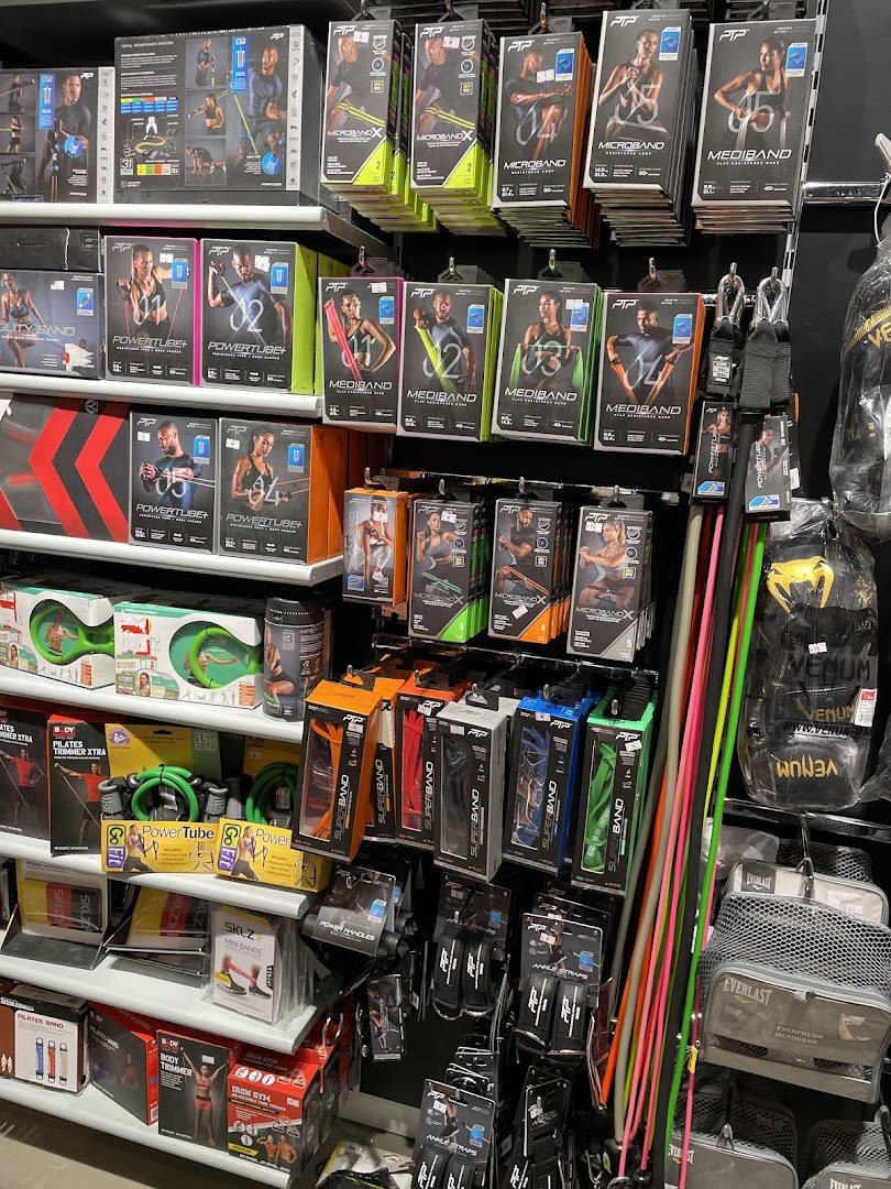 A retail display showcasing various fitness equipment, including resistance bands and tubes.
