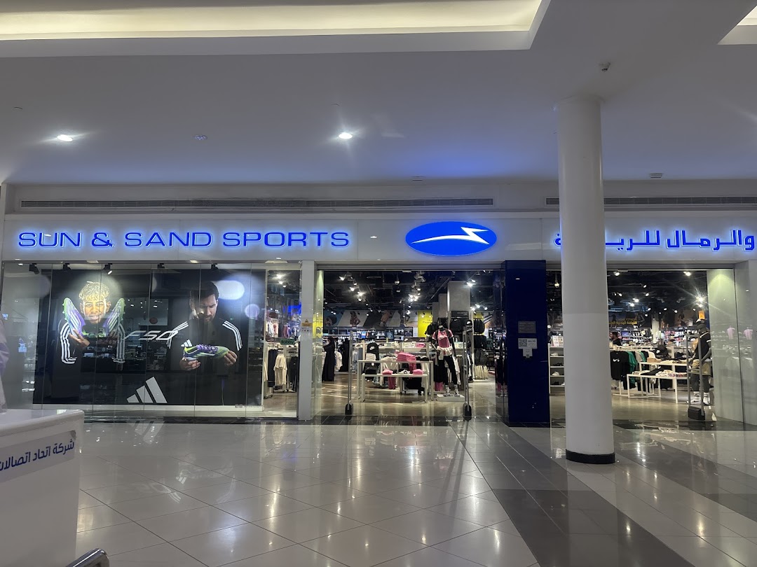 The Sun & Sand Sports store entrance with prominent branding and sports apparel displays.