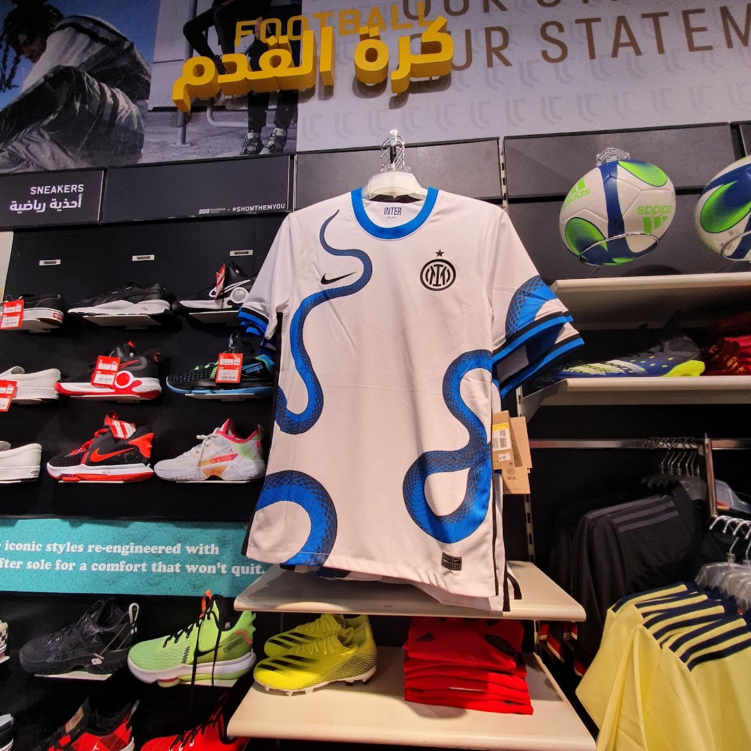 A display of football jerseys, sneakers, and soccer balls at Sun Sand Sports.
