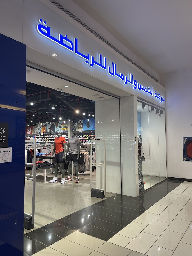 The entrance of Sun Sand Sports, featuring mannequins in athletic wear and a well-lit interior.