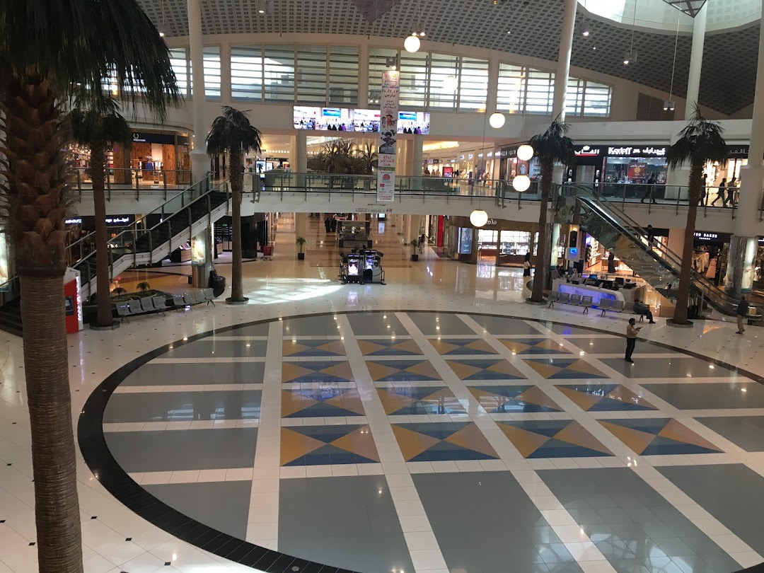 Interior view of a modern shopping mall with multiple levels and shops.