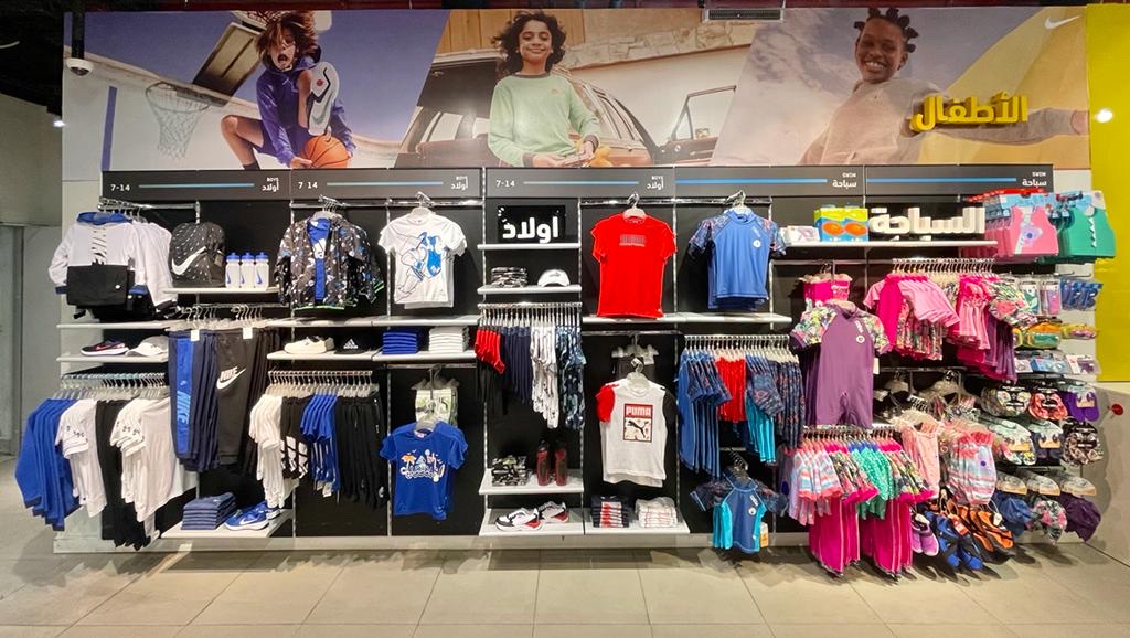 A vibrant display of children's sportswear and apparel from Sun Sand Sports.