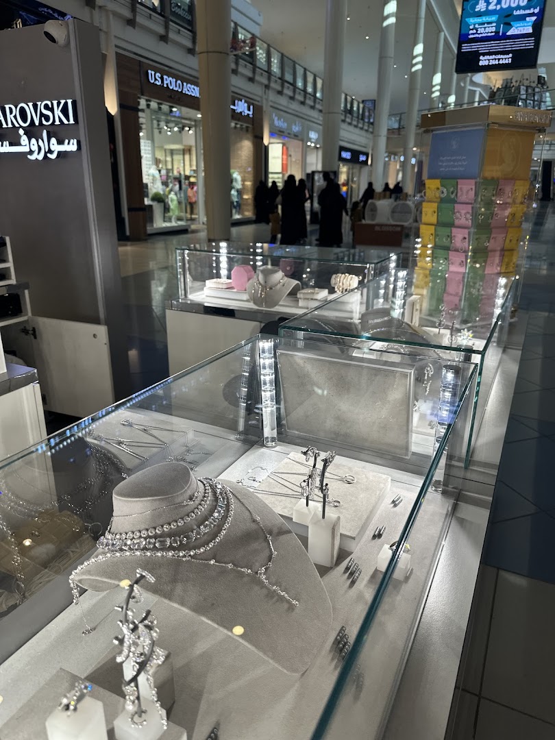 Swarovski shop interior showcasing sparkling jewelry in display cases.