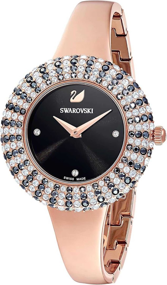 A close-up of a rose gold Swarovski watch with a black dial and crystal-embellished bezel.
