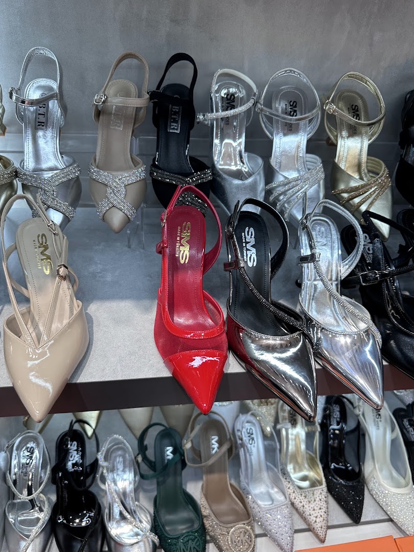 A display of various women's high-heeled shoes in different colors and styles.