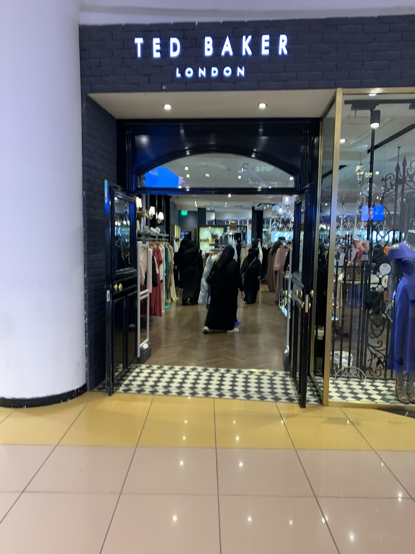 The entrance to a Ted Baker London clothing store with mannequins and clothing displayed inside.