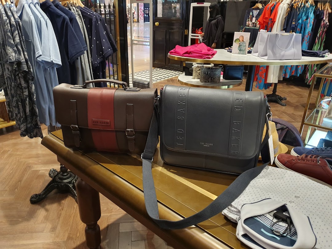 Ted Baker store interior showcasing stylish bags, clothing, and shoes on display.