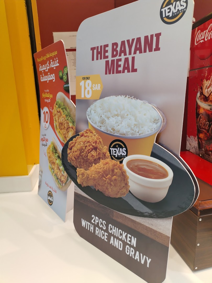 A promotional display for Texas Chicken's Bayani Meal featuring fried chicken, rice, and gravy.