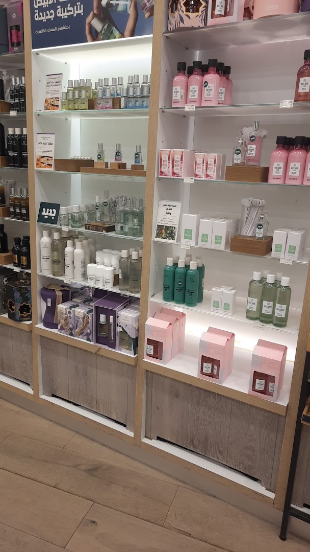 Shelves filled with various Body Shop skincare and fragrance products.