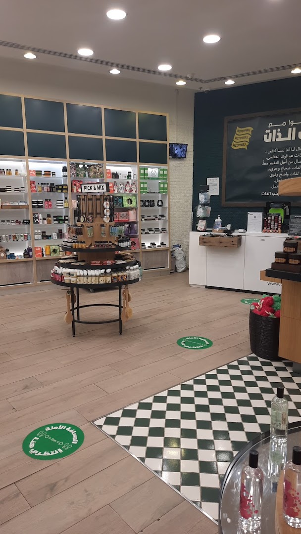 Interior view of The Body Shop with shelves of products and a central display.
