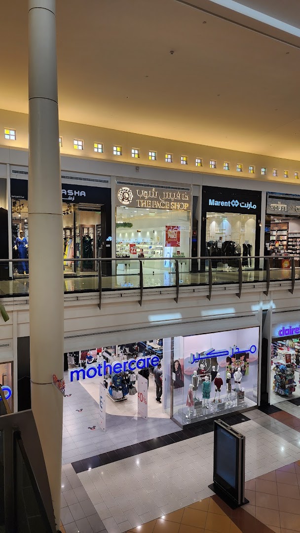 A view of The Face Shop and other stores on a mall's upper level.