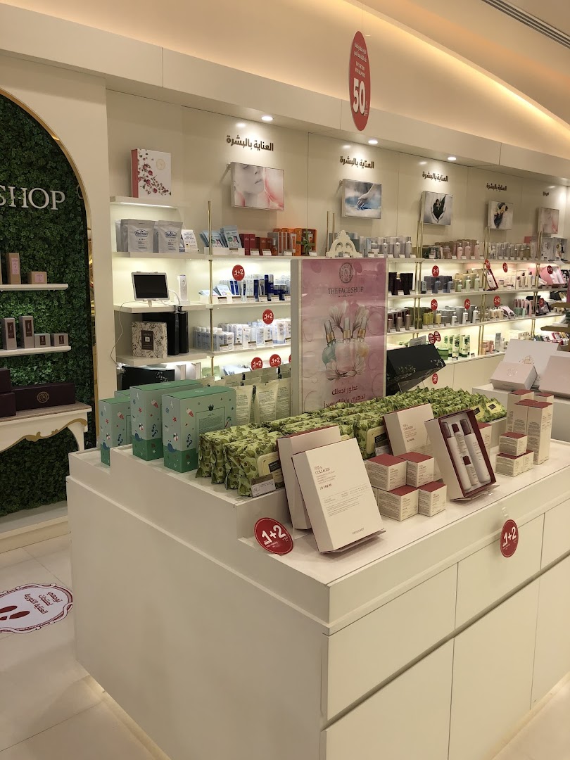 Interior view of a well-lit beauty shop with shelves displaying skincare products and promotional signage.