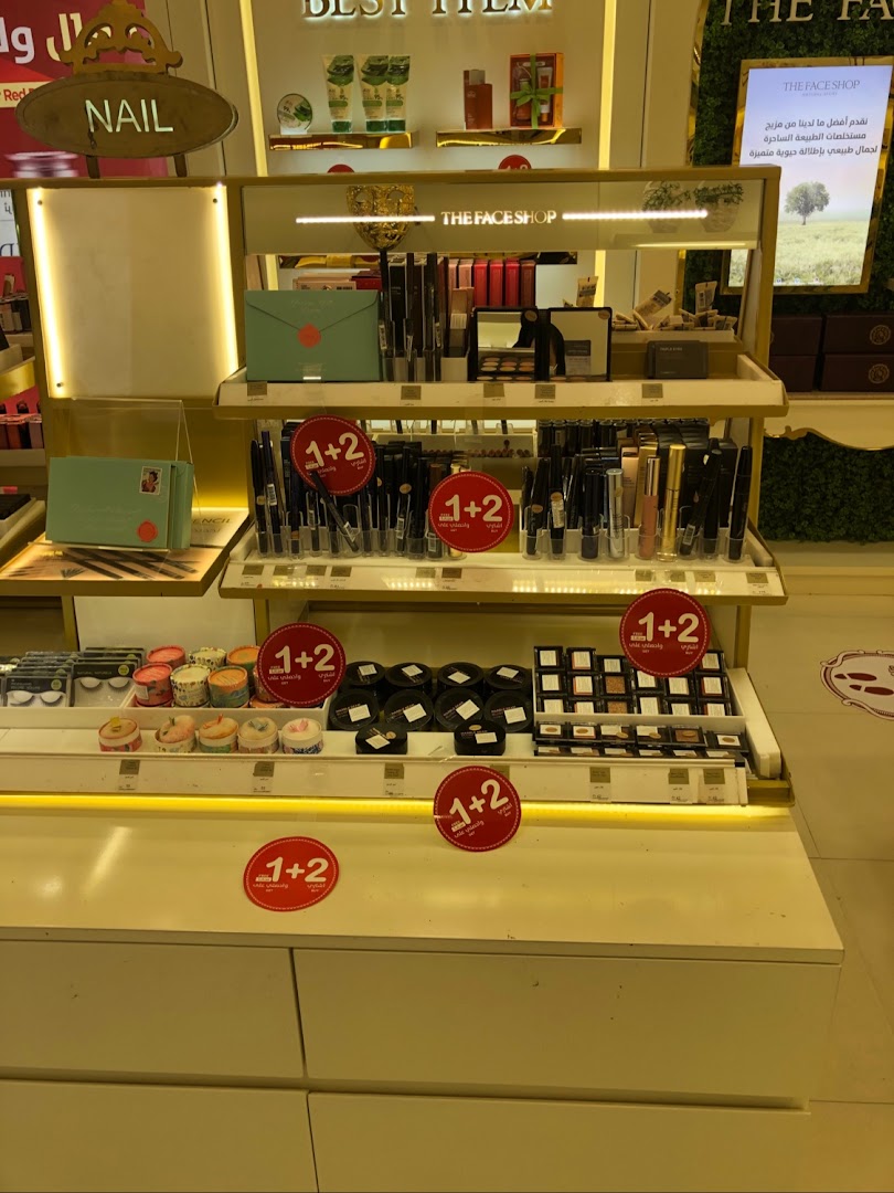 A display of makeup and skincare products at THE FACE SHOP, featuring a 1+2 promotion.