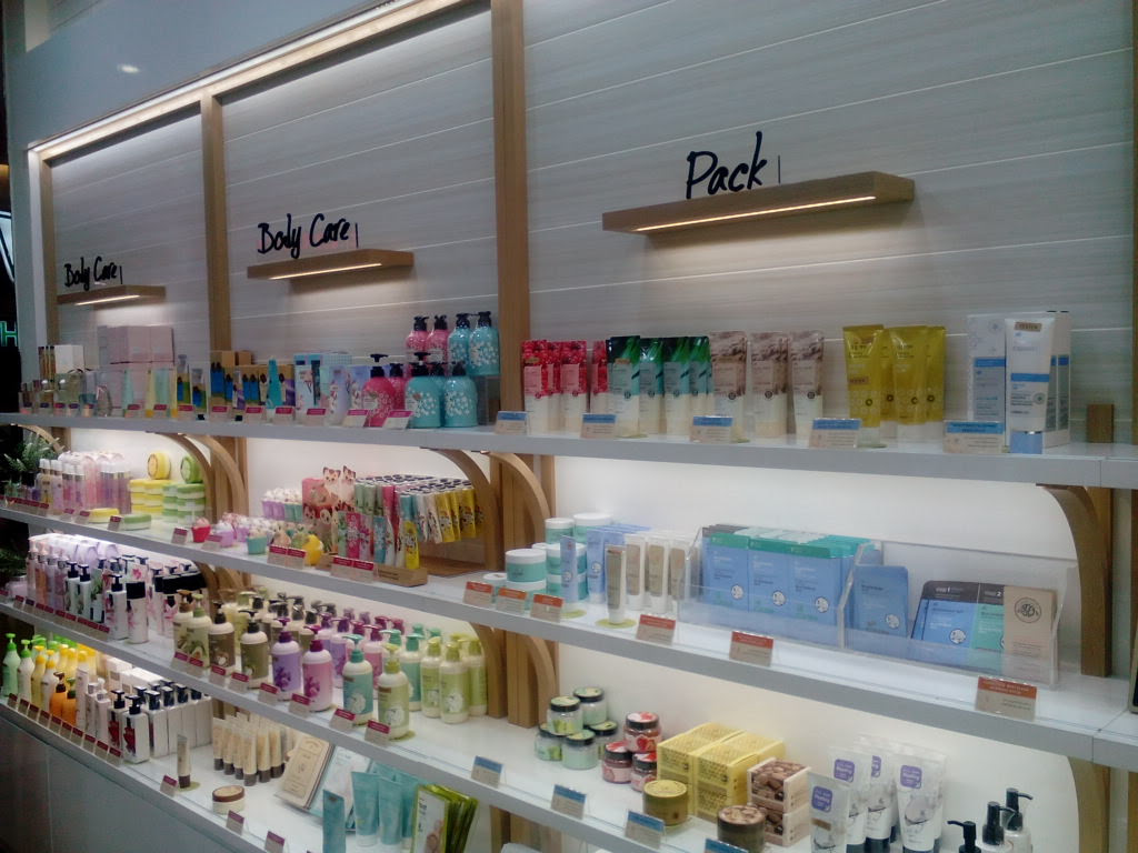 Shelves filled with various skincare and body care products from THE FACE SHOP.
