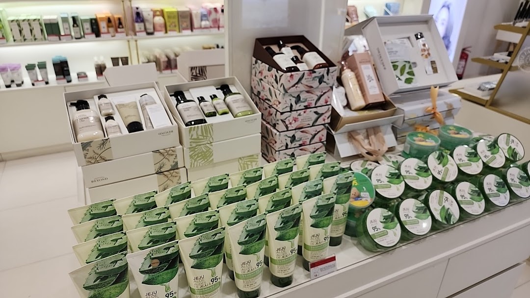 A display of skincare products, featuring gift sets and aloe vera-themed items.