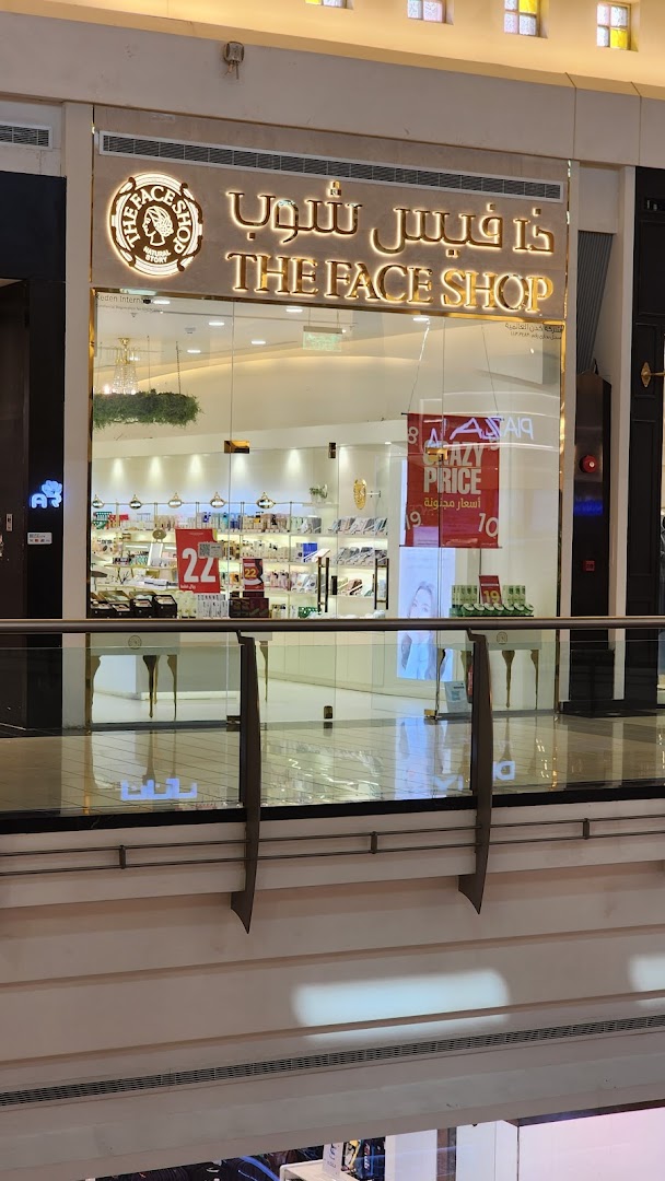The Face Shop storefront with illuminated signage and displays of beauty products.