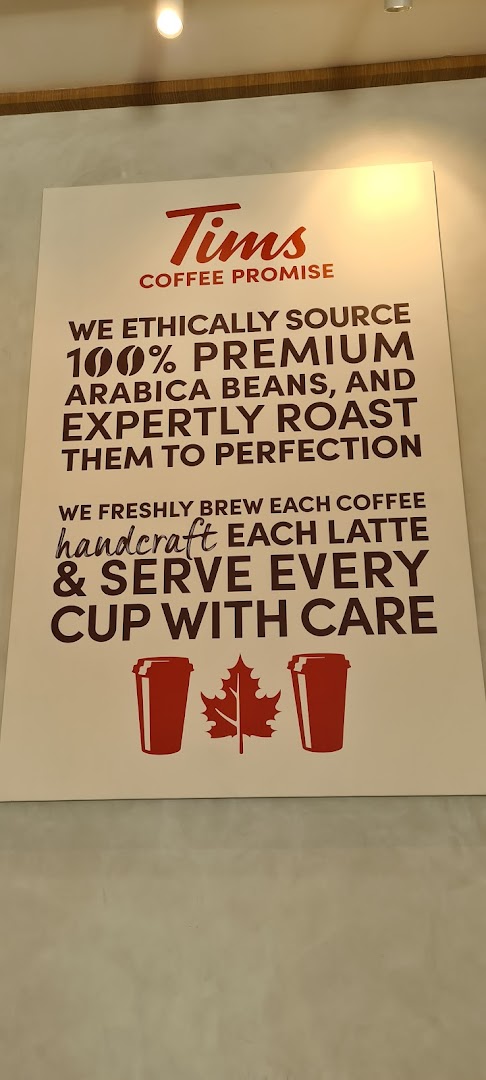 A sign detailing Tim Hortons' coffee promise, highlighting ethically sourced beans and expert roasting.