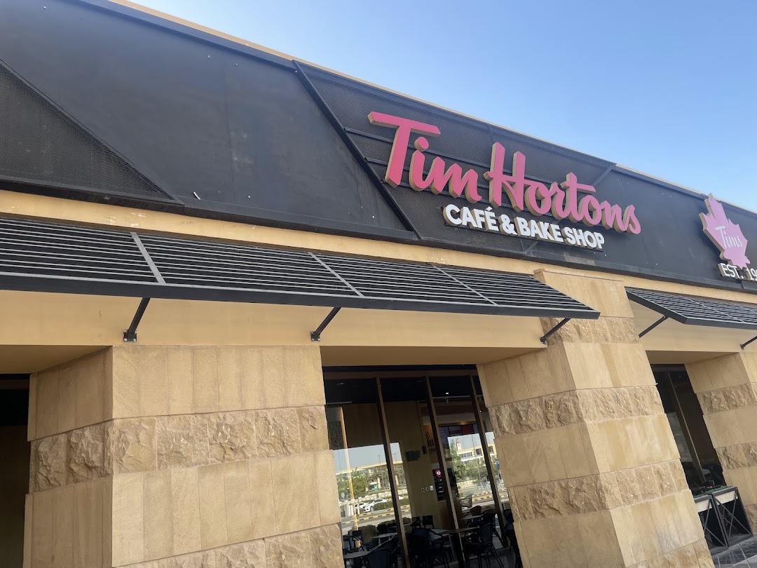 The exterior of a Tim Hortons cafe and bake shop with its prominent signage.