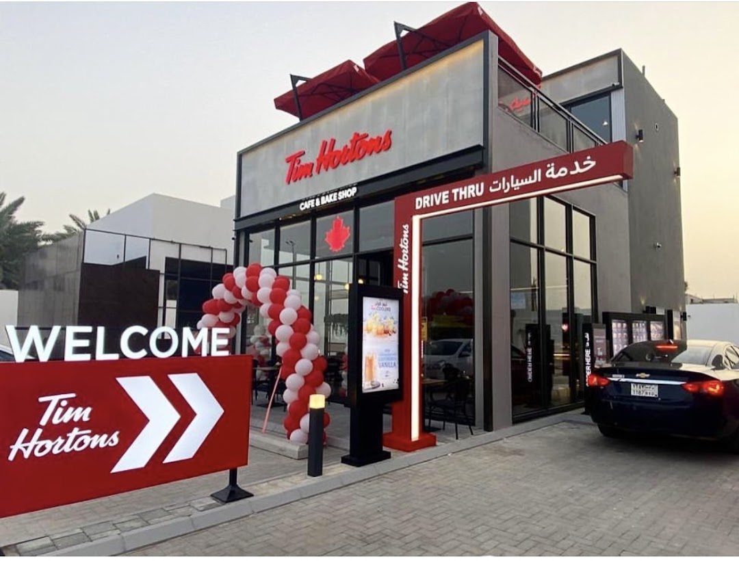 Tim Hortons cafe and bake shop with a drive-thru and a welcome sign.