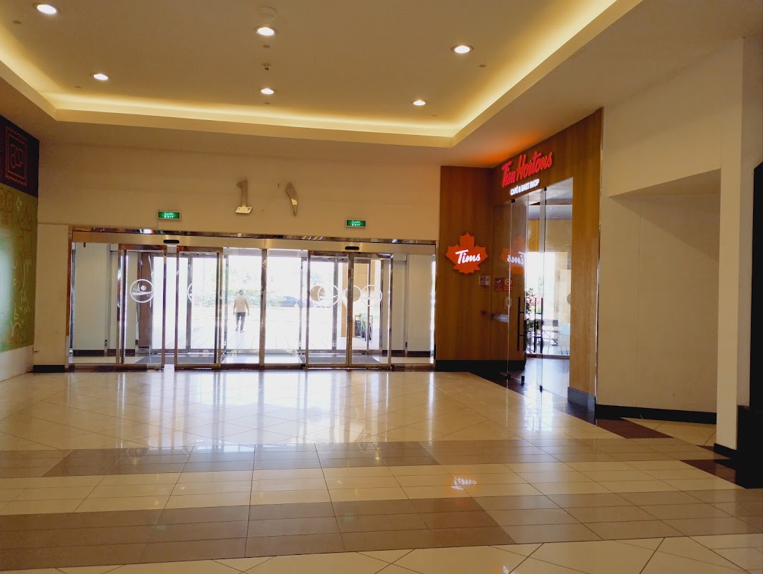 The entrance to a Tim Hortons cafe and bake shop with automatic glass doors.
