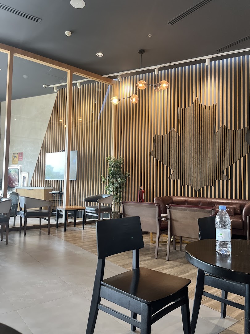 Interior of a Tim Hortons cafe with modern seating and decorative wooden wall panels.