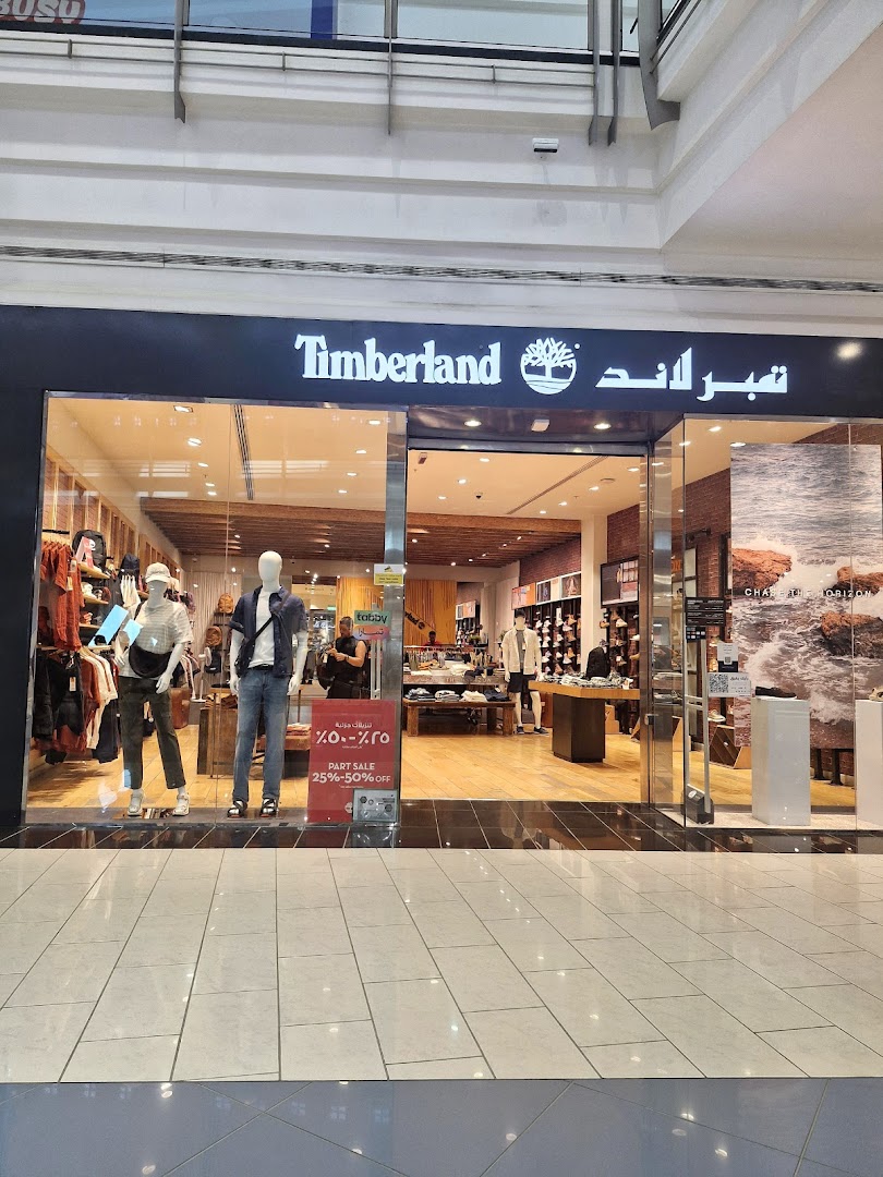 The Timberland store entrance with mannequins and sale signage.