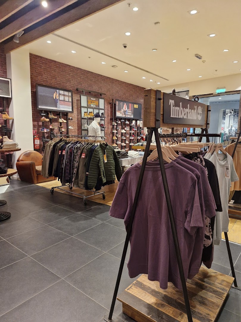 Interior view of a Timberland store showcasing apparel and footwear displays.