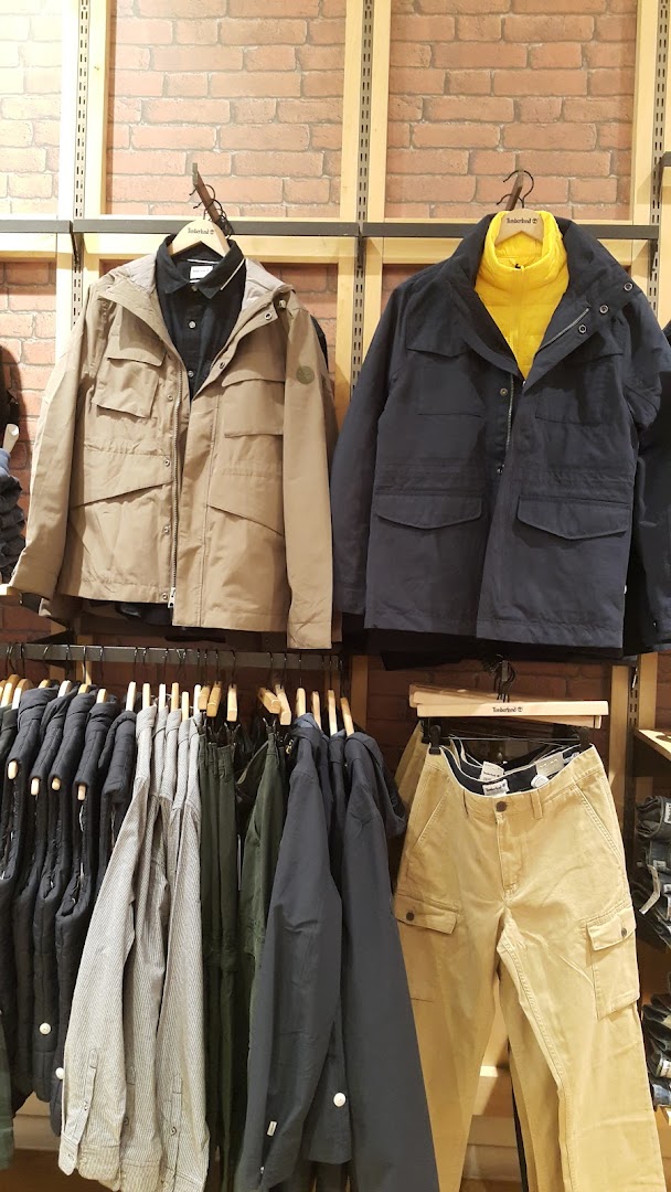 Timberland store display featuring jackets, shirts, and pants.