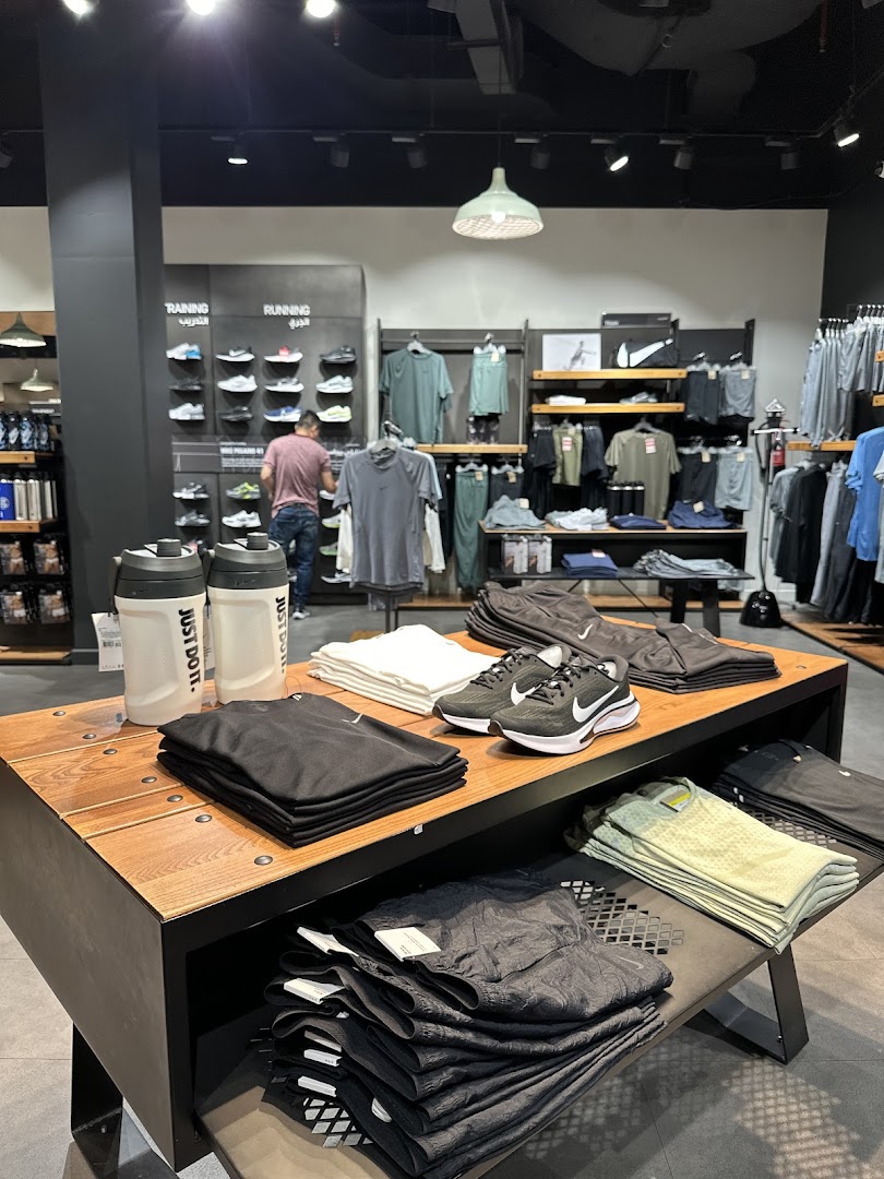 Interior view of a Nike store showcasing athletic apparel and footwear.
