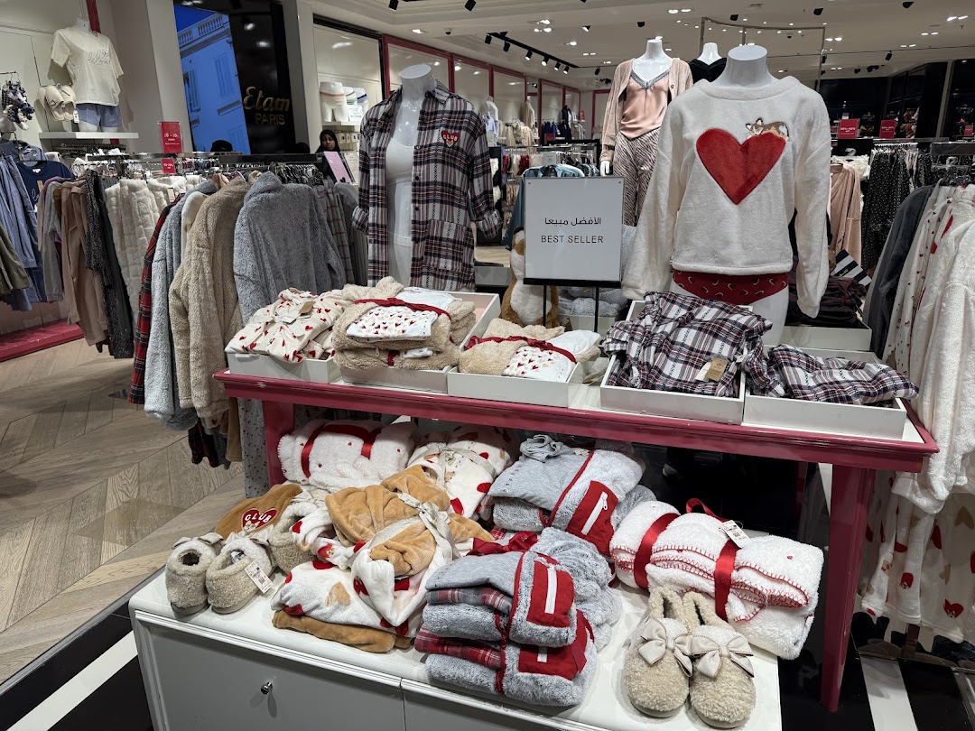 A display of cozy pajamas and slippers, featuring heart prints and soft fabrics.