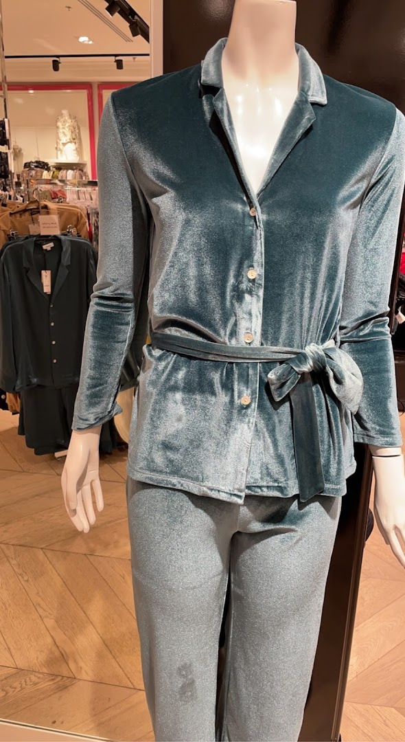 Mannequin wearing a teal velvet pajama set with a belted top and matching pants.