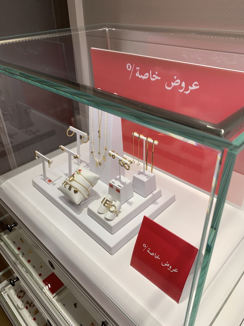 A display case filled with elegant jewelry, including necklaces, earrings, and bracelets.