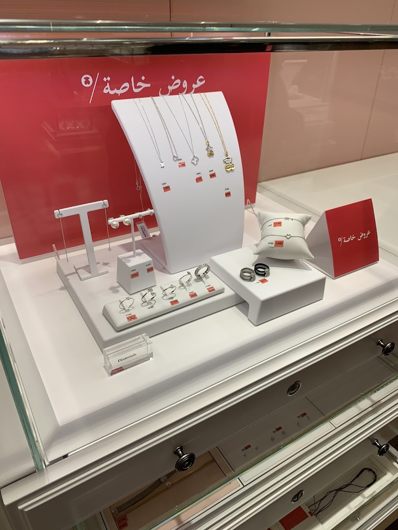 A display case showcasing various necklaces, rings, and bracelets from the Tous jewelry store.