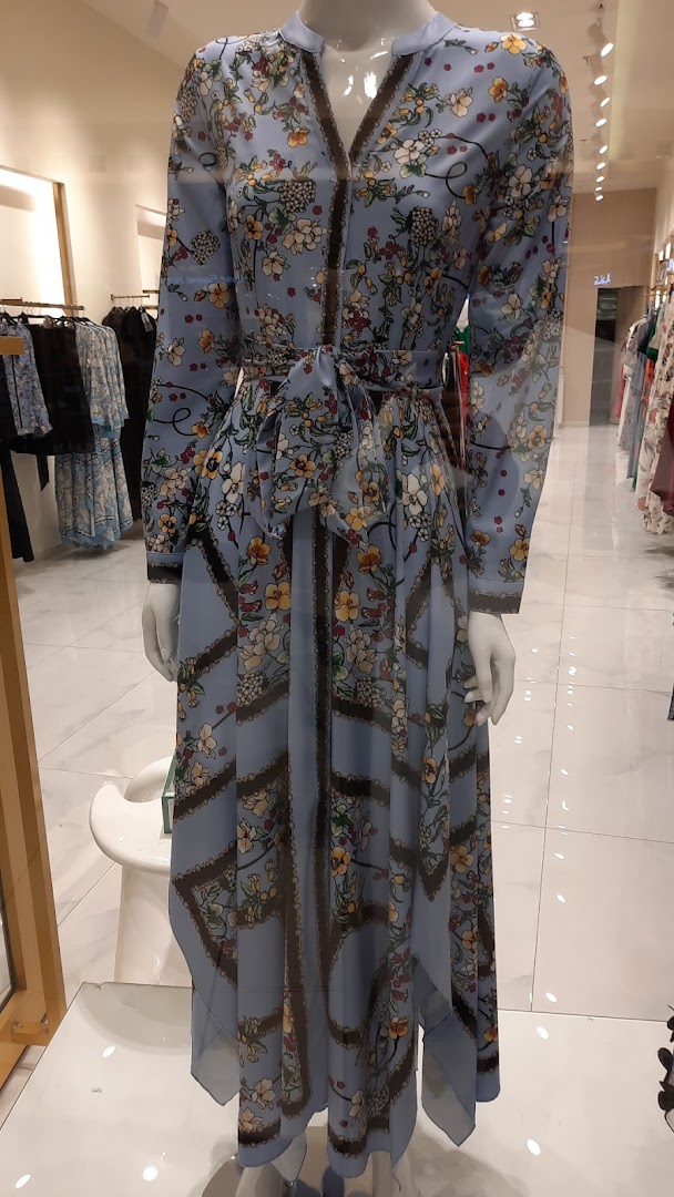 A light blue floral print dress displayed on a mannequin in a retail store.