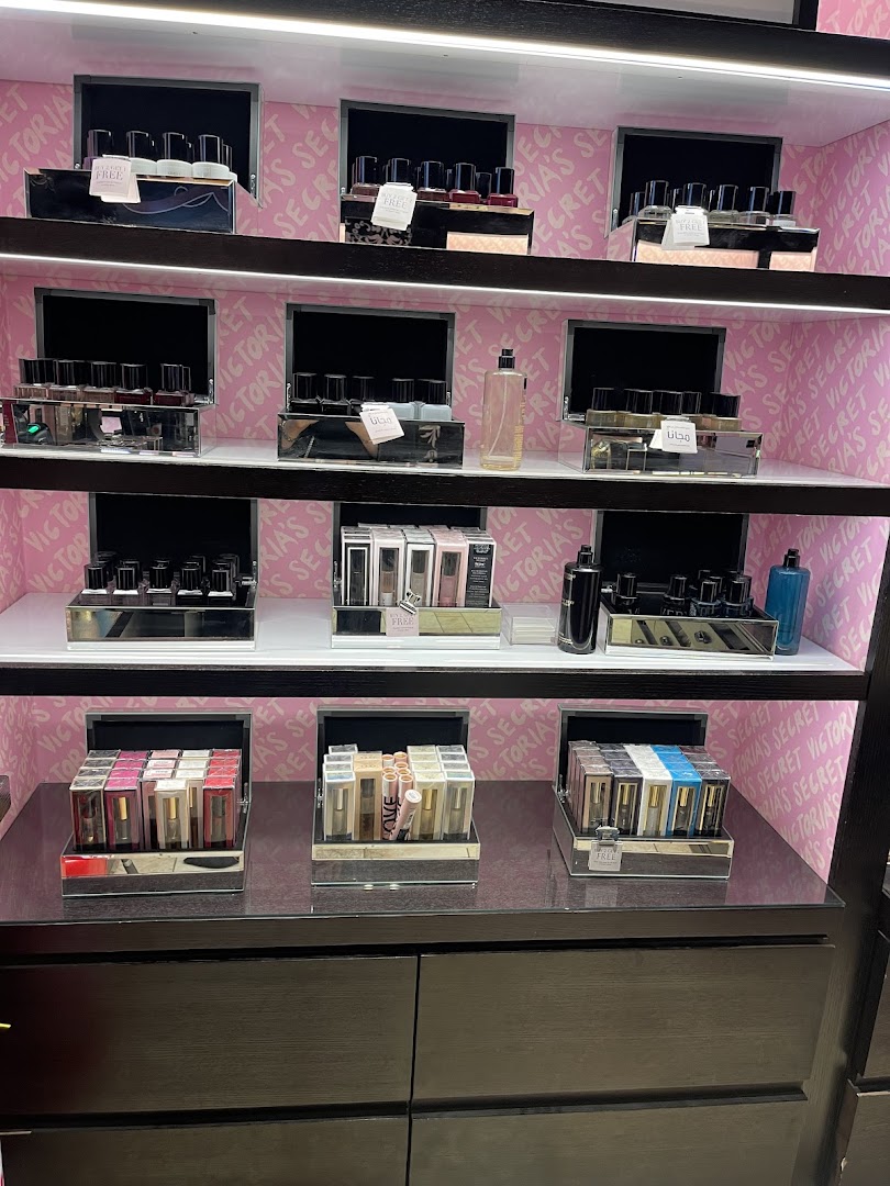 Shelves display various perfumes and beauty accessories from Victoria's Secret.