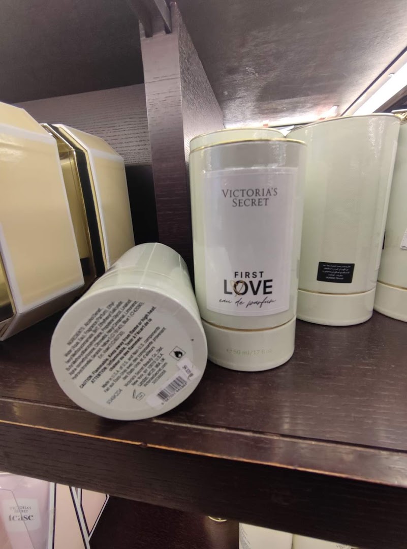 Victoria's Secret 'First Love' Eau de Parfum bottles displayed on a shelf.