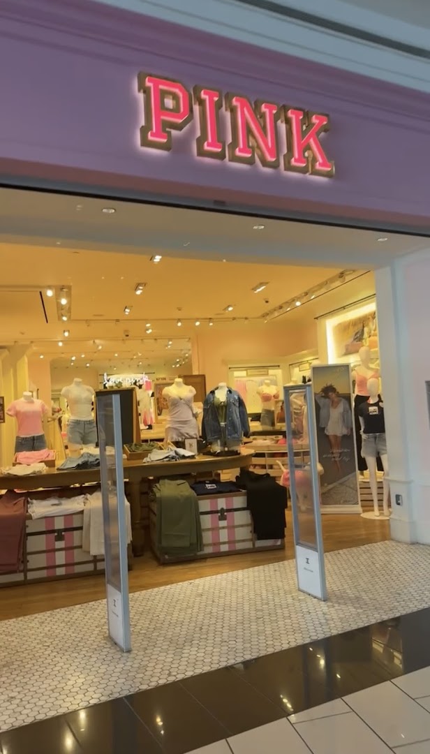 The entrance of a PINK Victoria's Secret store with mannequins displaying apparel.