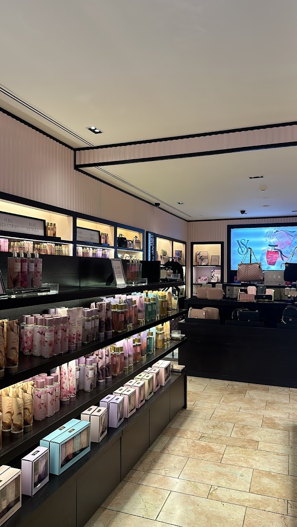 Interior view of a Victoria's Secret store showcasing rows of perfumes, lotions, and gift sets.