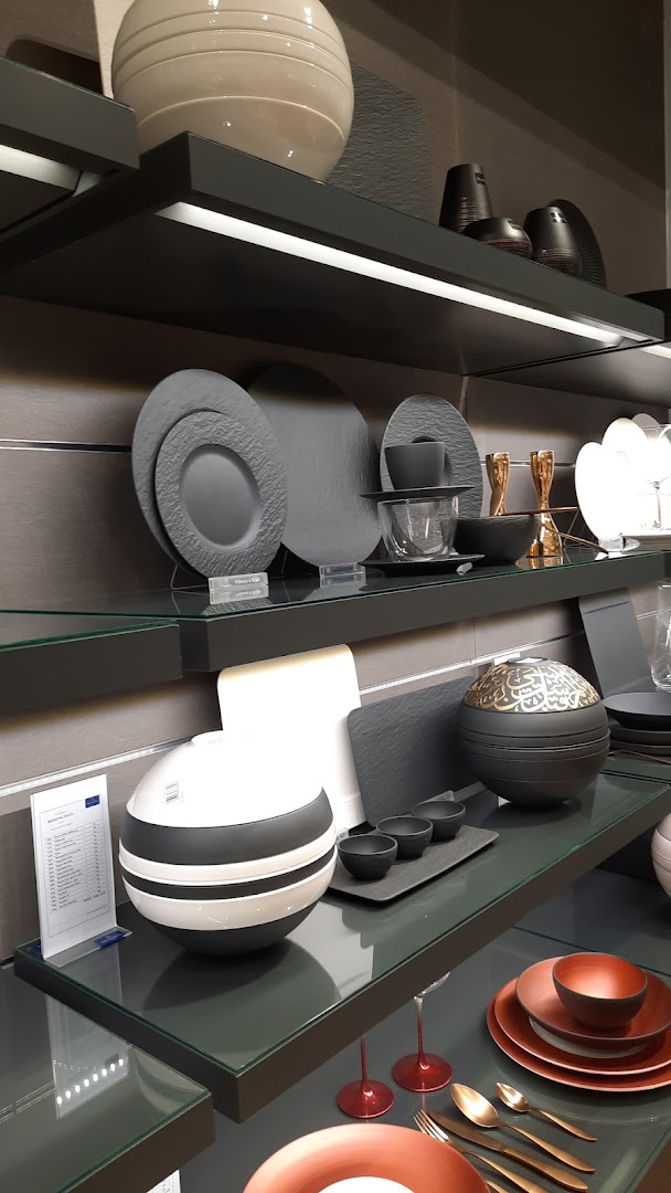 A display of elegant Villeroy & Boch tableware, including plates, bowls, and decorative items.