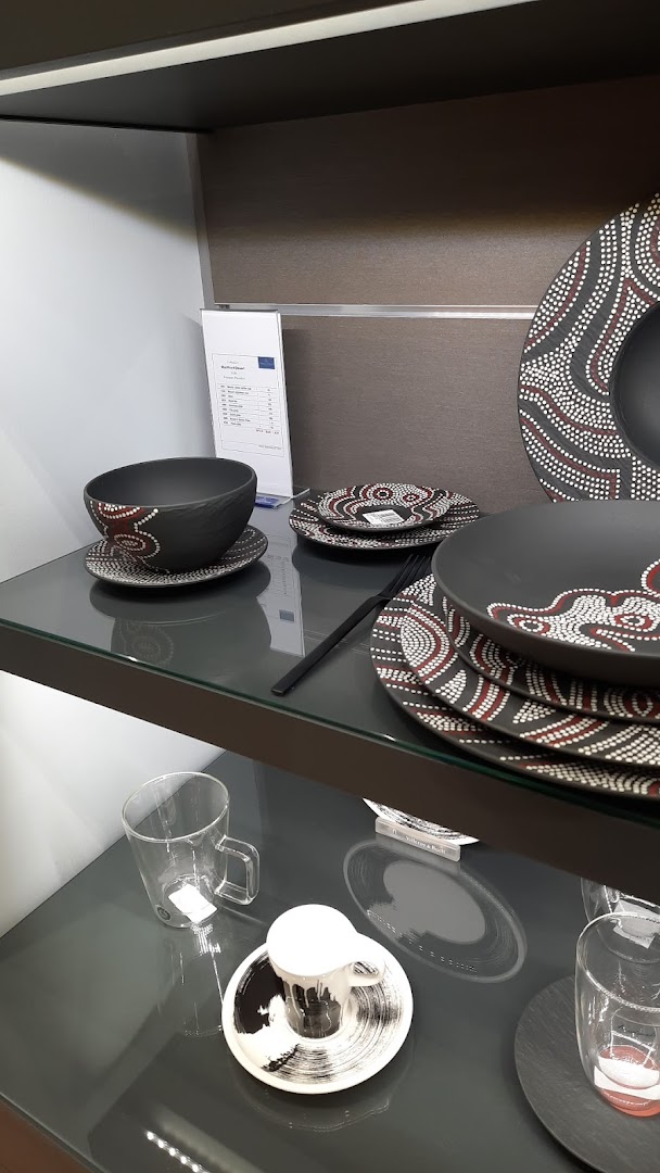 Display of Villeroy & Boch tableware with Aboriginal-inspired patterns and modern glassware.