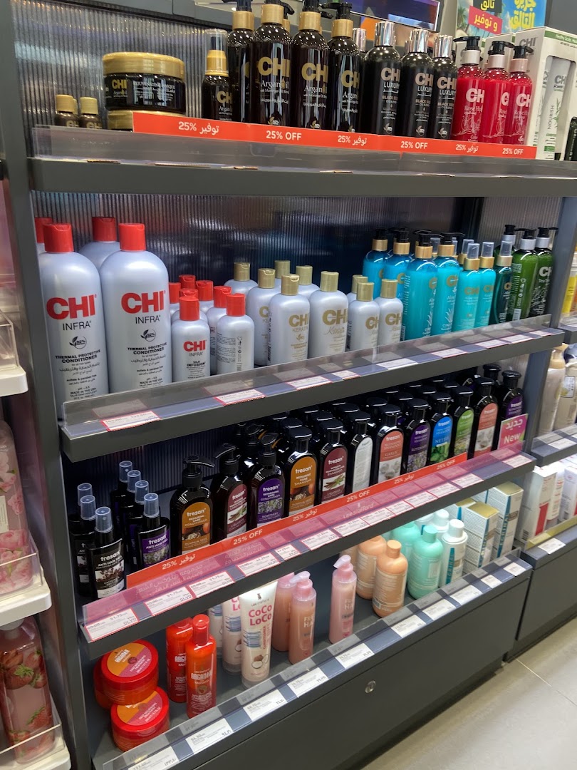 Shelves stocked with various hair care products, including shampoos, conditioners, and styling treatments.