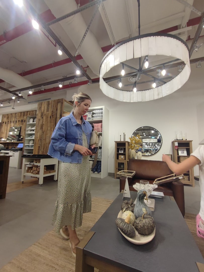 A woman shops for home decor in a modern furniture store.