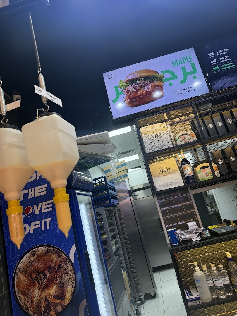 Interior view of a fast-food restaurant with a menu board and food items on display.