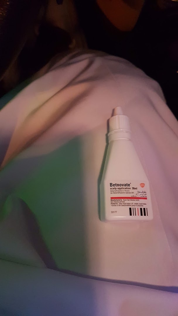 A bottle of Betnovate scalp application is placed on a white cloth.