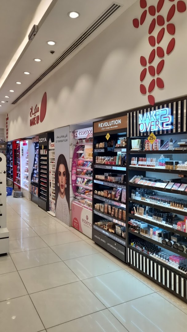 A well-lit interior view of a cosmetics store showcasing various makeup brands and products.