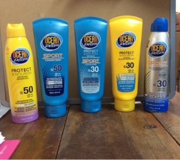 A collection of Ocean Potion sunscreen products displayed on a wooden surface.