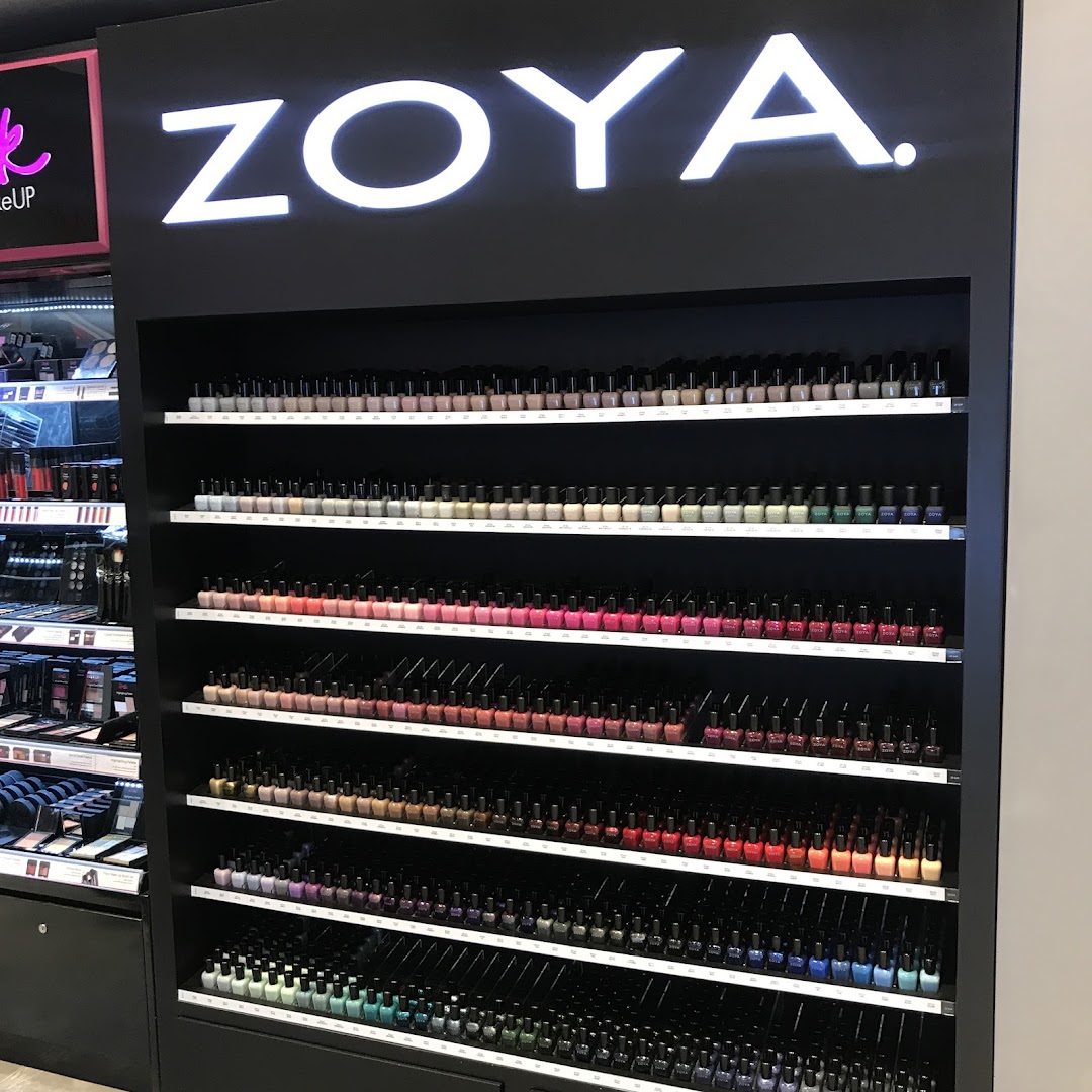 A display shelf filled with rows of colorful nail polish bottles under the Zoya brand.