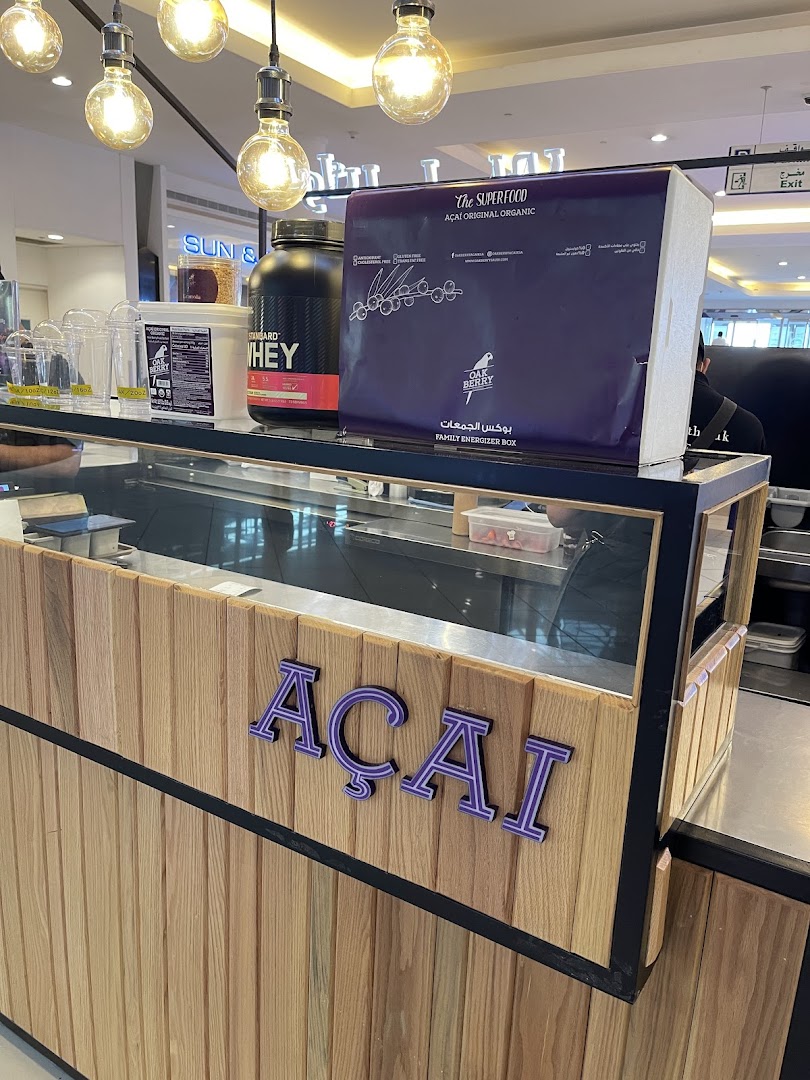 A counter display at Oakberry Acai featuring acai products and supplements.
